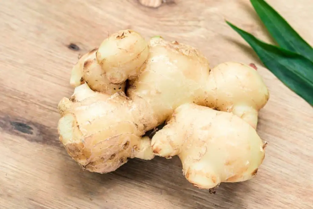 white garlic on brown wooden table