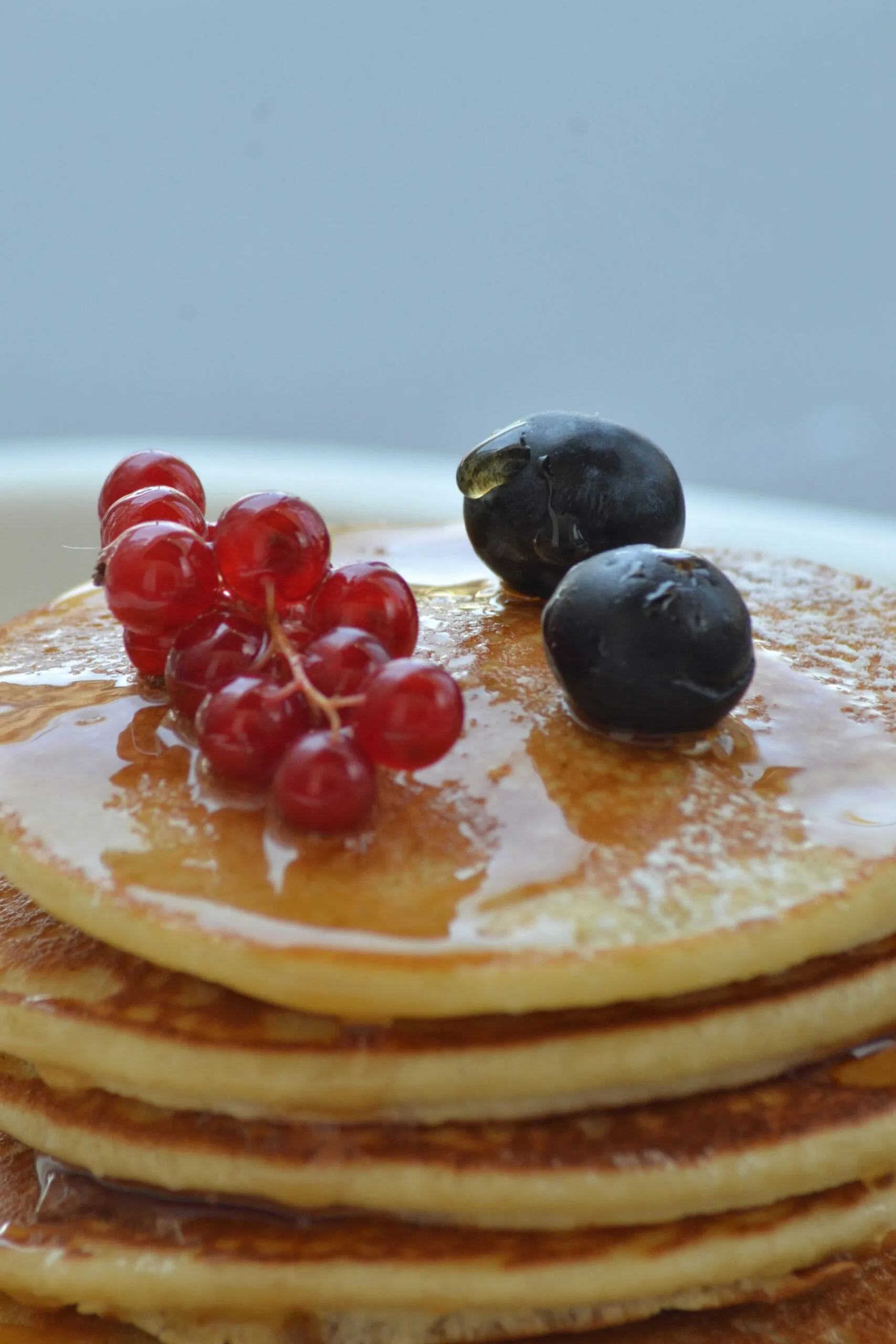 The Ultimate Pancake Recipe: Fluffy, Delicious, and Easy to Make red and black berries on white ceramic plate